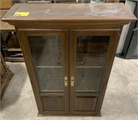 Wooden glass cabinet measures approximately 27