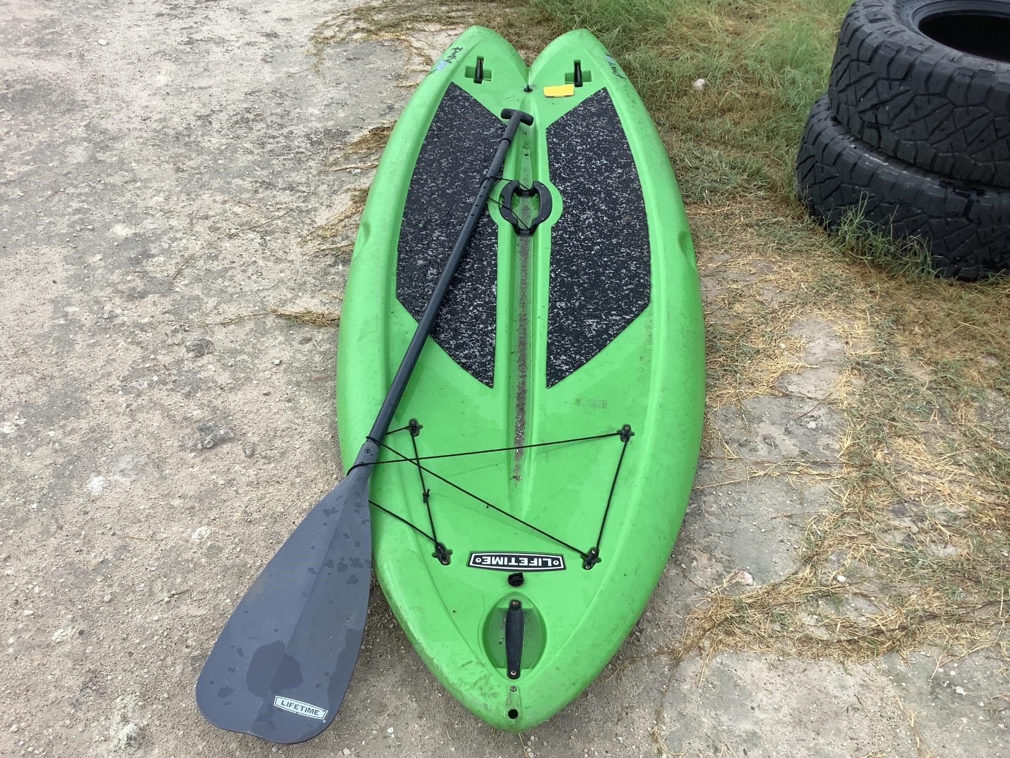 GREEN KAYAK AND PADDLE