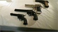 four commemorative pistols and revolvers