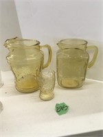 2 gold depression glass pitchers & a glass