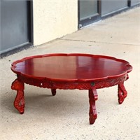 Red Oriental round table with scalloped edge