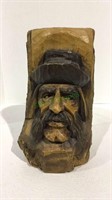 Carved wooden face of man and log measuring 9