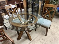 Round glass top table with wood base and two wood