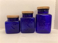 Three Blue Glass Canisters with Wood Lids
