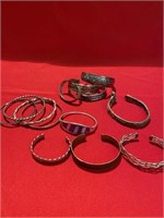 Bracelets. Some sterling silver, some not. Wide