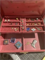 Vintage jewelry box with lapel pins, charms and