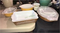 Four pieces of Pyrex baking dishes and one mug,