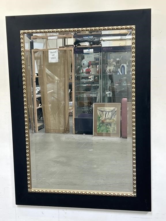 Wood-framed beveled glass mirror