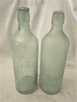 Lot of 2 green glass bottles with lids