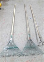 Two rakes and a garden tool