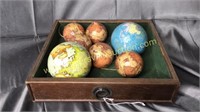 Old drawer with mini globes
