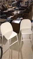 Pair of white molded plastic chairs with seat