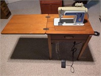 Singer model 604 sewing machine in cabinet