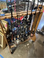 LARGE AMOUNT OF FISHING POLES W ROLLING STAND