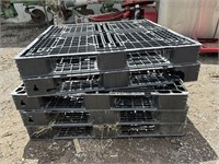 4 black plastic skids