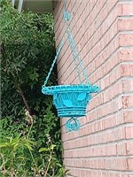 Blue metal ornate hanging flower basket.