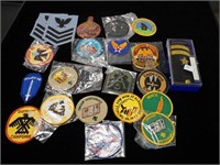 Two containers of military and Scout badges,