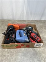 Assortment of electric power tools and drill bits