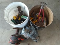Two buckets of assorted fencing supplies