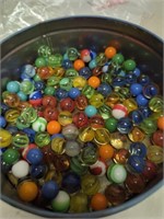 old candy tin with marbles  cat eyes