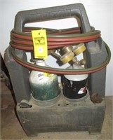 Torch set with acetylene and oxygen tanks.