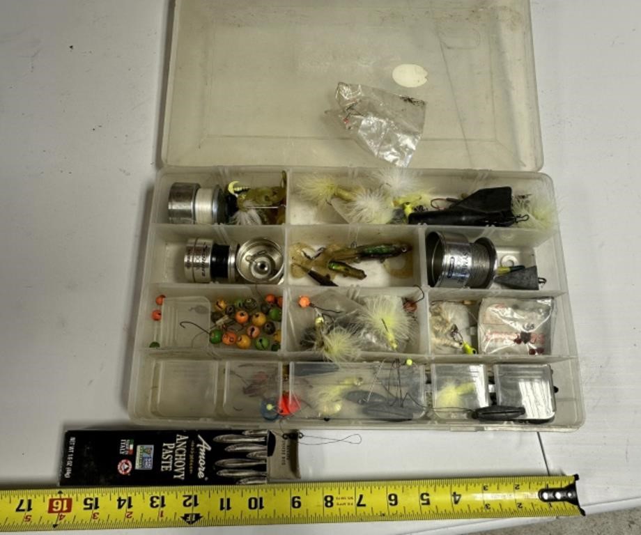 box of fish lures, reel parts, anchovy paste