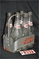 Antique Pepsi-Cola metal carrier and bottles