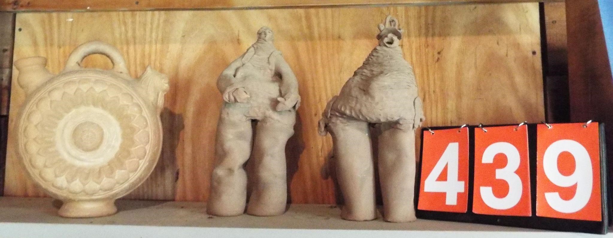 3 clay figures on shelf