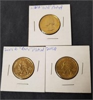 Three gold-plated quarters 2011 P, 2005d and 2005
