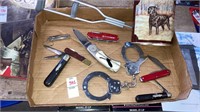 Tray of pocket knives handcuffs retriever tin