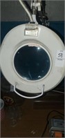 Electric light with magnifier lens.