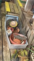 Watering cans, tomato cages, planter supplies