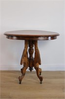 ANTIQUE SIDE TABLE ON CASTERS W ORNATE BASE