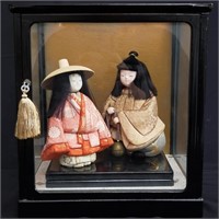 Geisha dolls in glass display box