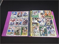 Binder of Seahawks and cowboys football cards