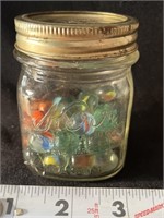 Small jar of vintage marbles