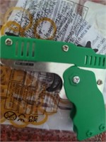 New chrome & green folding rubber band gun with a