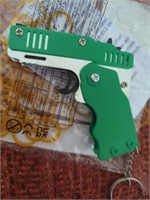 New chrome & green folding rubber band gun with a