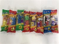 Eight unopened PEZ dispensers with the candy