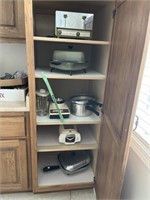 Cabinet full of assorted kitchen appliances