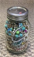 Quartz glass jar filled with costume jewelry.