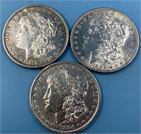 3 Morgan silver dollars: 1884 O, 1921, 1886