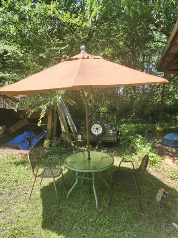 Outdoor patio table, 2 metal chairs and umbrella.