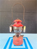 Vintage Red Coleman lantern glass appears intact