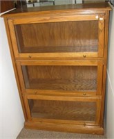 Three section oak lawyer's cabinet. Measures 48"