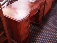 Nine-drawer serpentine wood kneehole desk with