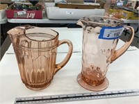2 pink glass pitchers