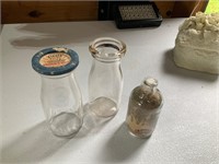 vintage small milk bottles and jar of sand