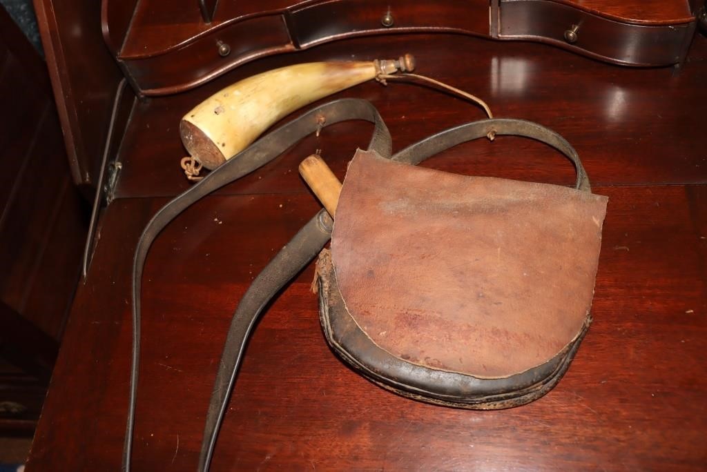 Leather pouch with powder horn, knife, cap tins,