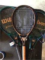 Three tennis rackets with covers